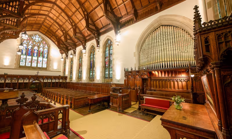Harris Manchester College chapel, looking towards the South Windows with the oainted organ pipes